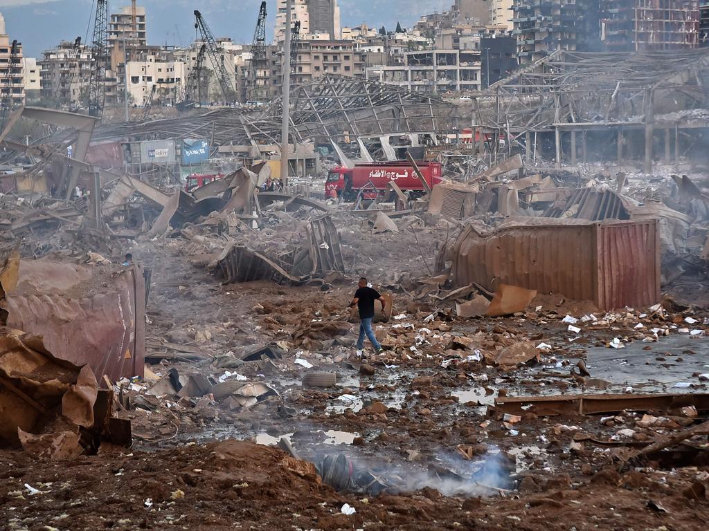 Smoke rises out of the debris at the port. Picture: AFP