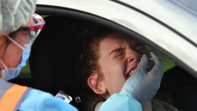 A medical worker takes a swab from a woman at a coronavirus testing station in Picton, south-west of Sydney. Picture: AFP