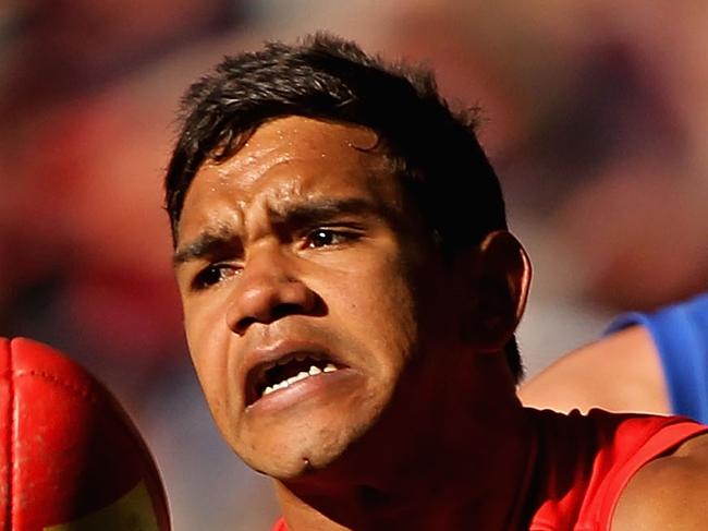 MELBOURNE, AUSTRALIA - AUGUST 03: Neville Jetta of the Demons handballs during the round 19 AFL match between the Melbourne Demons and the Brisbane Lions at Etihad Stadium on August 3, 2014 in Melbourne, Australia. (Photo by Robert Prezioso/Getty Images)