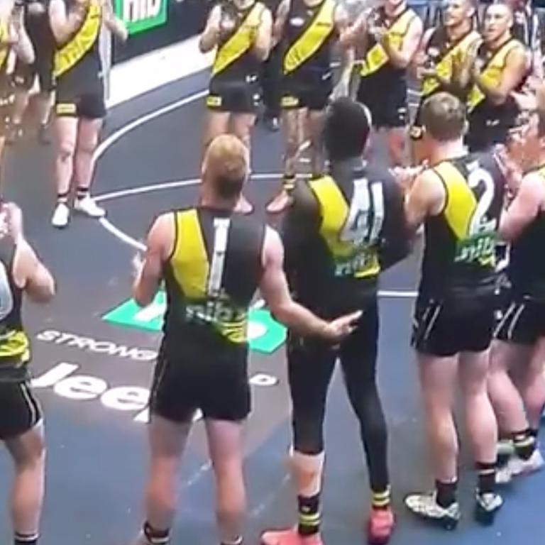 A Richmond player is seen groping Mabior Chol during the team song.