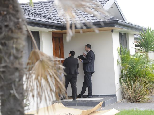 Police doorknock in the area where Mr Garmo was found fatally stabbed. Picture: Phillip Rogers