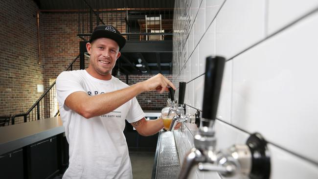 Mick Fanning pours a beer at his Balter brewery at Currumbin. Picture: NIGEL HALLETT