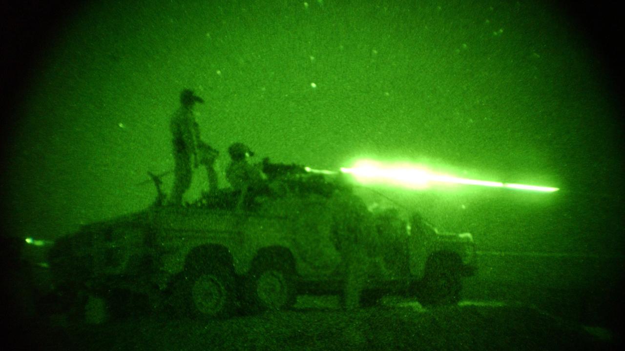 Australian Special Forces Task Group (SFTG) members firing their vehicle mounted heavy weapons at night in Afghanistan.