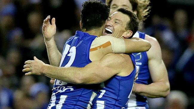 Brent Harvey celebrates a goal with Lindsay Thomas in his record-breaking game. Picture: Mark Stewart