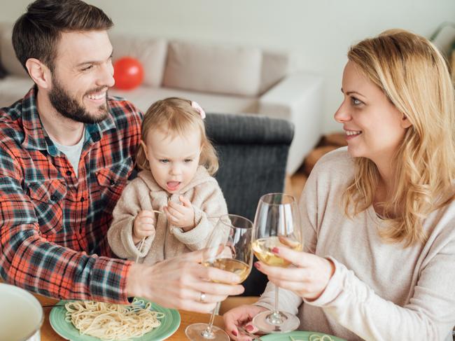 Young parents with a child having Italian food at home. Picture: iStock