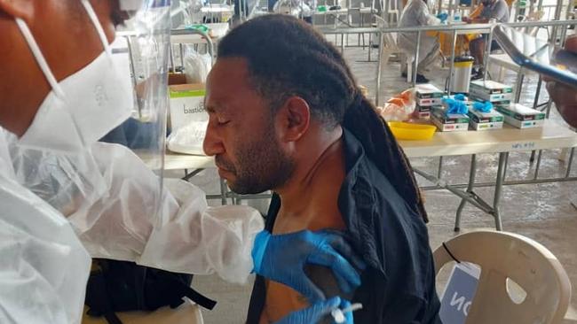 Larsen Marape, the PNG Prime Minister’s brother, receives one of the precious first doses donated by Australia for frontline health workers in the impoverished country.