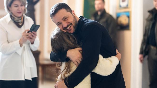 Ukrainian President Volodymyr Zelensky hugs a child during an awards ceremony in Kyiv. Picture: AFP / Ukrainian Presidential Press Service