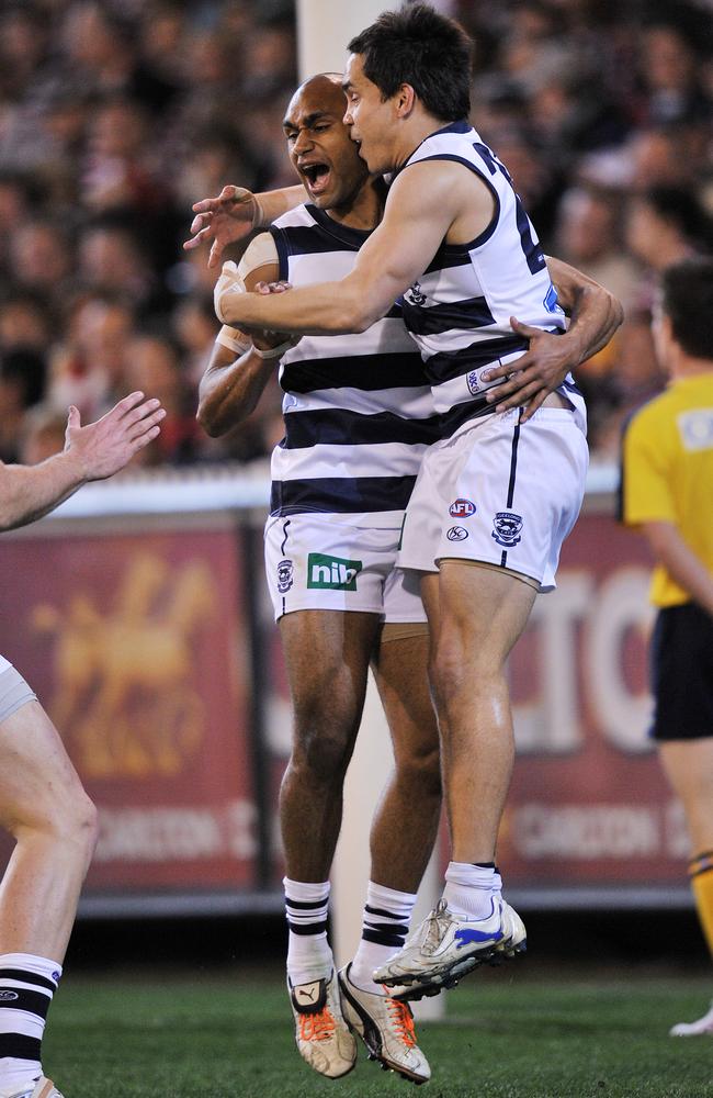 Varcoe and Mathew Stokes celebrate a win with Geelong in 2010.