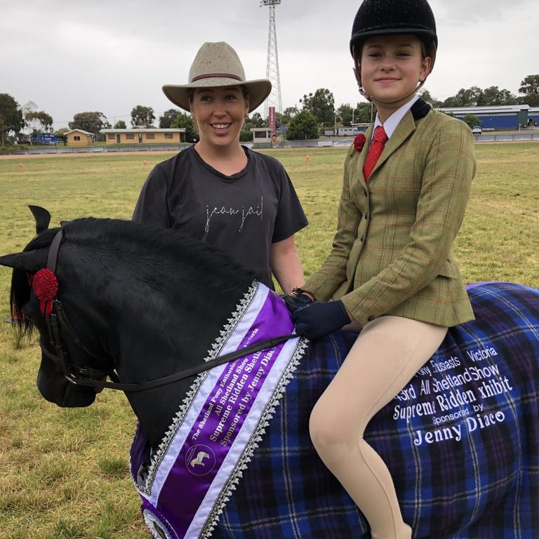 Ester Robinson standing with her pony Carreg Wen Bartley, co-owned by Warren Coyle, with rider Hahana Young, 12.