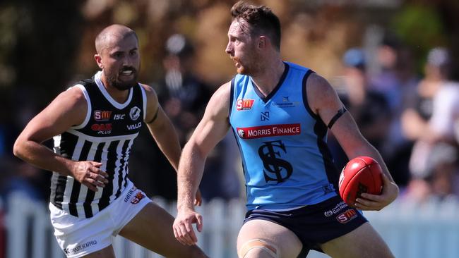 Aiden Riley of Sturt looks to get past Josh Simpson of the Magpies