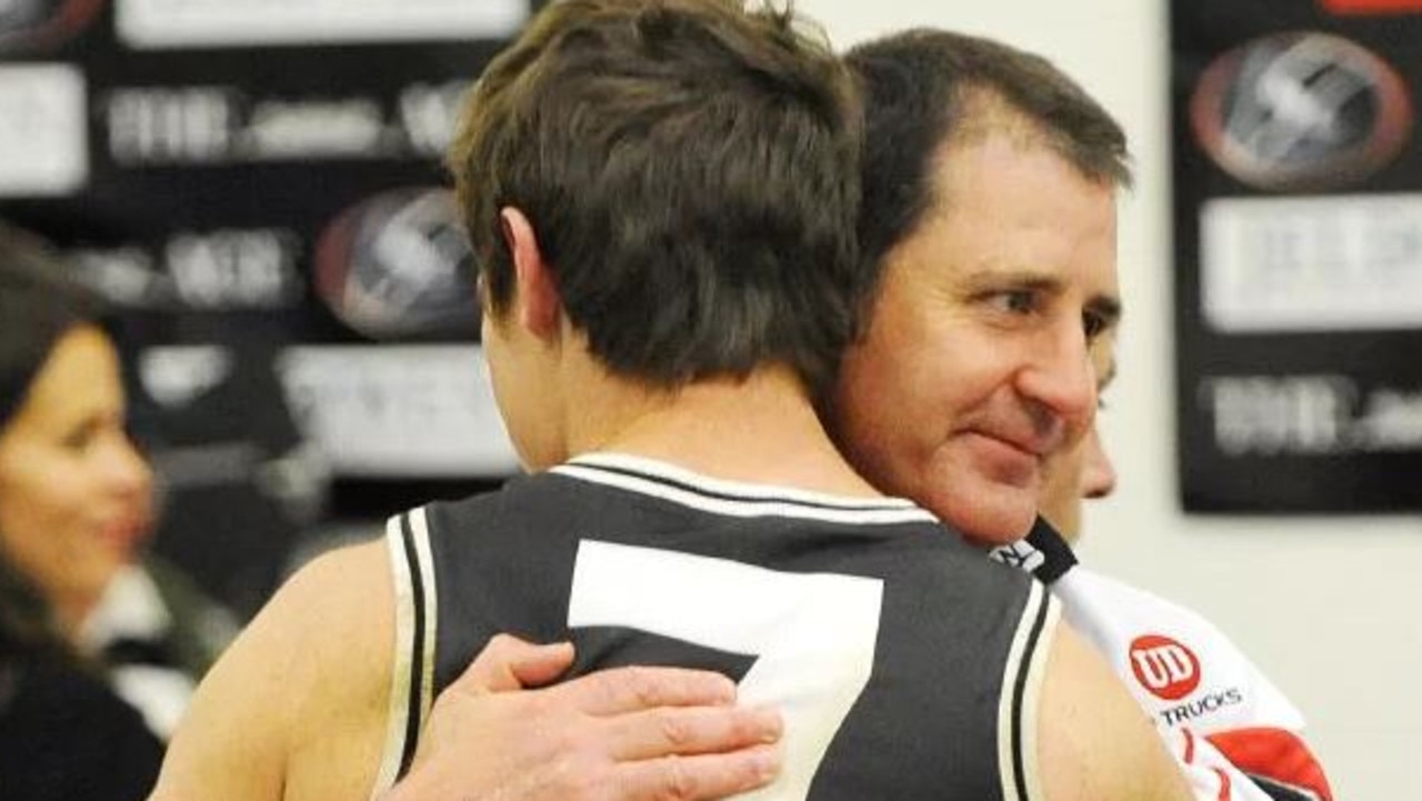 Ross Lyon hugs Lenny Hayes after a St Kilda game.