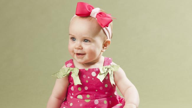 Baby girl in pink sitting , Generic, Picture; Getty Images