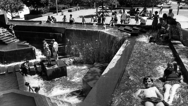 People swimming in the fountains at the City Square.