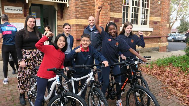 Dandenong Primary Students Hareem, Shefket, Naomi and Abigail (left – right) test ride four hand built bikes donated to the school by Energy United. Image: Gemma Scerri