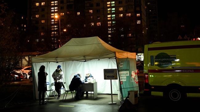 People wearing face masks to protect against COVID-19 take part in the seasonal flu vaccination campaign in Moscow a few days ago. Picture: AFP