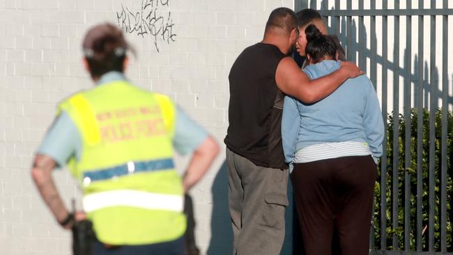 People comfort each other at the scene of the double stabbing.