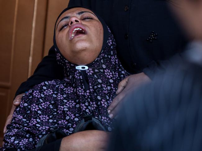 People mourn as they collect the bodies of Palestinians killed in an air strike in Khan Yunis, Gaza. The United Nations deems nowhere in Gaza is safe for civilians. Picture: Getty Images