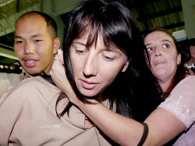 JULY 4, 2003 : Australian Holly Deane-Johns is hugged by her sister Amy (R) as Thai prison official escorts her from Bangkok criminal court, 04/07/03 having been sentenced to 31-years in jail while compatriot Robert Halliwell, received life in prison, after two were arrested on 09/00 with 135 grams of heroin in their possession.Thailand / Crime / Drug Traffic