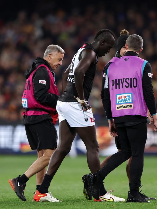 Aliir is taken from the field. Picture: Getty