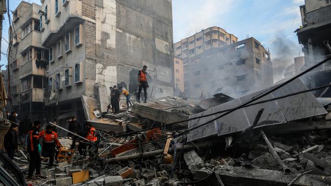 Palestinian citizens inspect the destruction caused by air strikes on their homes. Picture: Ahmad Hasaballah