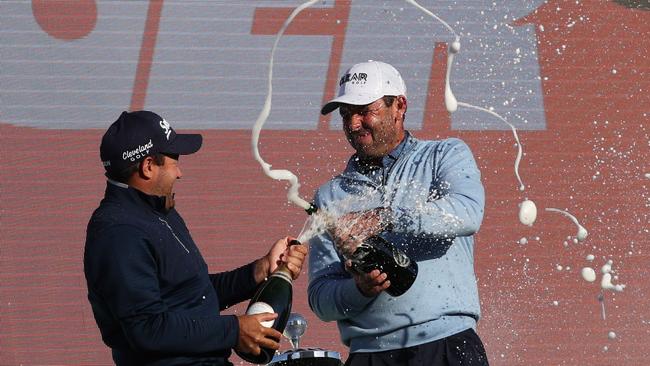 Charl Schwartzel (R) and Hennie Du Plessis (L) celebrate after the final round. Picture: Adrian Dennis/AFP