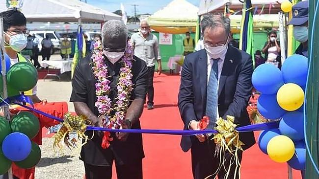 China's ambassador to the Solomon Islands Li Ming and Solomons Prime Pinister Manasseh Sogavare cut a ribbon during the opening ceremony of a China-funded national stadium complex in Honiara.