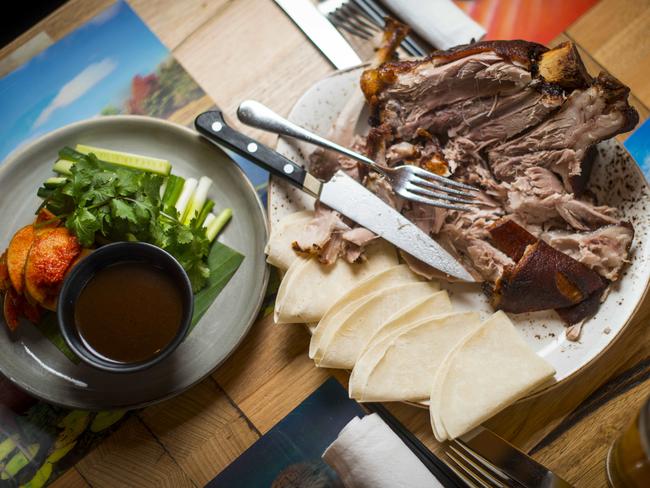 Korean style crispy pork hock with apple kimchi salad, pancakes and hoi sin. Picture: Eugene Hyland