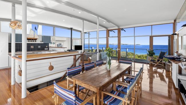 Glass envelopes the open-plan living area sporting plenty of nautical themes.