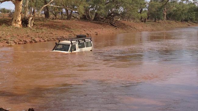 Chinese tourists stranded in a normally dry river bed on the road to Santa Teresa. PIC: SUPPLIED