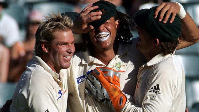 Shane Warne (left) and Adam Gilchrist (right) congratulate teammate Andrew Symonds for taking a catch to dismiss South Africa's batsman Nicky Boje in 2006.