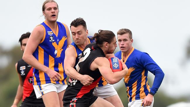 Somie’s Steve Crowe lays a hard tackle on Frankston Bomber Dale Sutton in the last quarter.