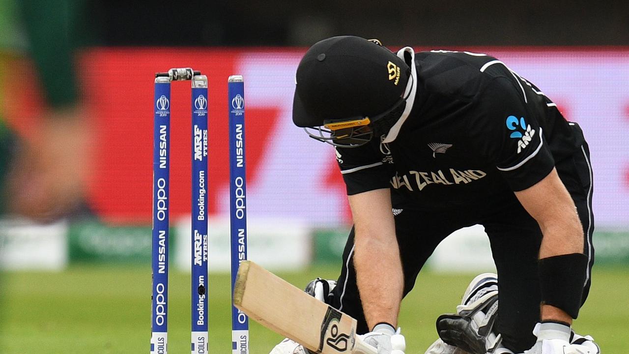 Martin Guptill looks at the stumps after knocking the bails off. Photo: Oli Scarff/AFP.