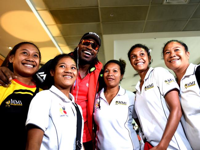 Chris Gayle stopped for photographs with PNG Womens Cricket Team at the Airport. Picture: AAP