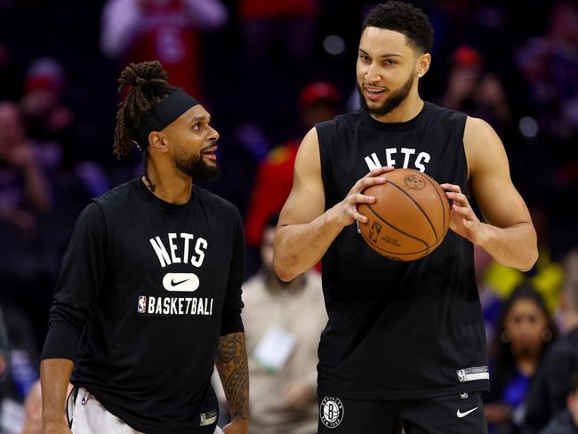 PHILADELPHIA, PENNSYLVANIA - MARCH 10:  Patty Mills #8 and Ben Simmons #10 of the Brooklyn Nets take the court for warm ups before the game against the Philadelphia 76ers at Wells Fargo Center on March 10, 2022 in Philadelphia, Pennsylvania. NOTE TO USER: User expressly acknowledges and agrees that, by downloading and or using this photograph, User is consenting to the terms and conditions of the Getty Images License Agreement. (Photo by Elsa/Getty Images)