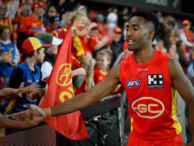 GOLD COAST, AUSTRALIA - JUNE 25: Hewago Paul Oea of the Suns celebrates wth fans during the round 15 AFL match between Gold Coast Suns and Hawthorn Hawks at Heritage Bank Stadium, on June 25, 2023, in Gold Coast, Australia. (Photo by Matt Roberts/AFL Photos/via Getty Images )