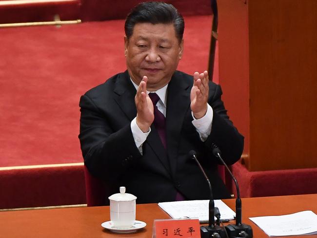 China's President Xi Jinping applauds during a celebration meeting marking the 40th anniversary of China's "reform and opening up" policy at the Great Hall of the People in Beijing on December 18, 2018. - President Xi Jinping warned on December 18 that no one can "dictate" China's economic development path as the Communist Party marked 40 years of its historic "reform and opening up" policy amid a stern challenge from the United States. (Photo by WANG Zhao / AFP)