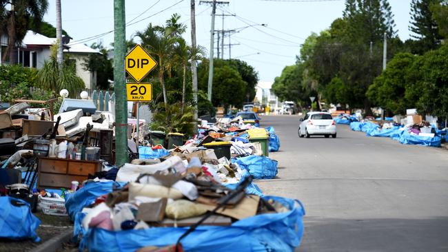 Piles of house contents destroyed in the Townsville floods line the street of Hodel St, Rosslea