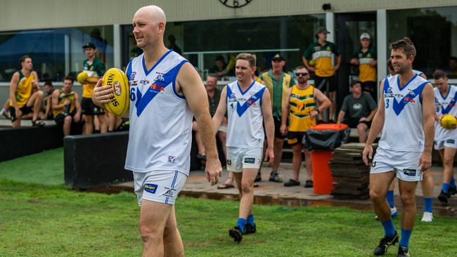 Banks Bulldogs FC's Liam Ogilvie-Mitchell (foreground) running out for his 200th NTFL match. Picture: Patch Clapp / AFLNT Media