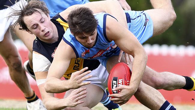 Glenelg’s Lachlan Earl tackles Sturt’s James Battersby. Picture Sarah Reed