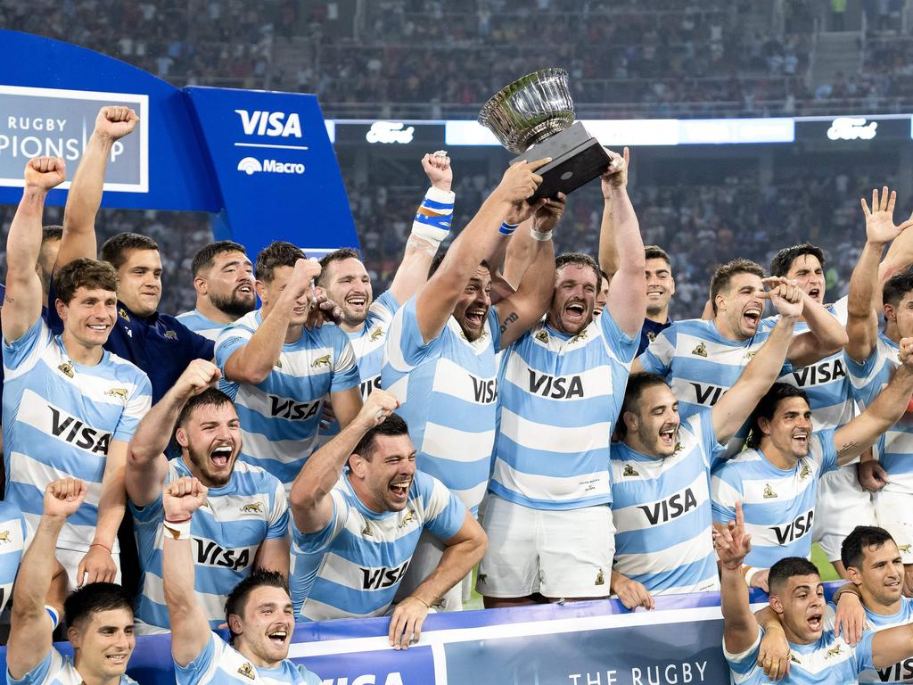 Argentine players celebrate with the trophy after winning the rugby union Championship match between Argentina's Pumas and South Africa's Springboks, at the Madre de Ciudades stadium in Santiago del Estero, Argentina, on September 21, 2024. (Photo by GERONIMO URANGA / AFP)