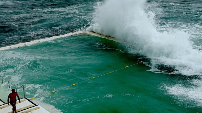 Large waves crash across Bondi pool as the east coast of the state continues to be inundated by wet weather on Sunday. Picture: Jeremy Piper