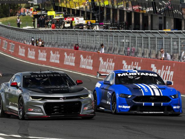 The Gen3 Chevrolet Racing Camaro and Ford Performance Mustang, on track at Mt Panorama, above, after being unveiled to the public during the Bathurst 1000 in December 2021. Picture: Daniel Kalisz/Getty Images