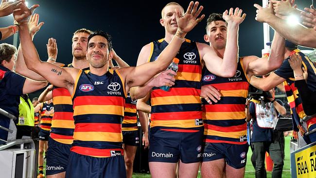 Adelaide players leave the ground after the club’s huge win. Picture: Getty Images