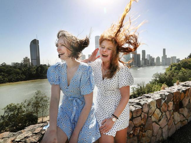 Britney Worbey and Sarah Purcell, both 19, brave the wind at Brisbane’s Kangaroo Point Cliffs. Picture: Tara Croser