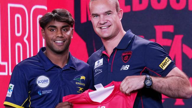 Kysaiah Pickett (left) is presented with a jersey by Brad Green.