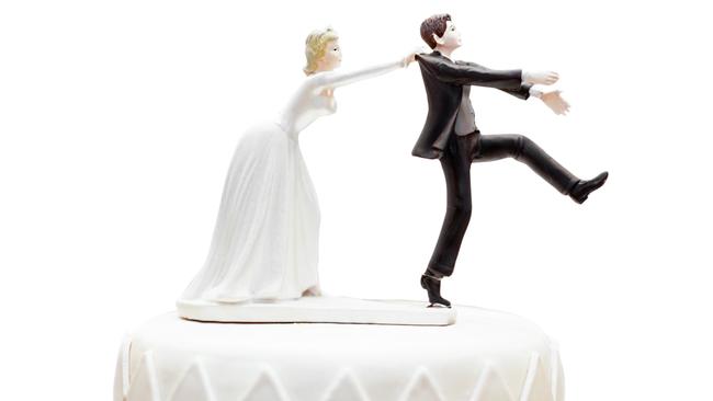 groom doll and statue is running away but bride can catch him finally. the funny wedding story doll on the top of cake with isolated object on white background and clipping path.