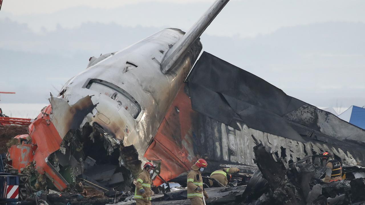 Firefighters work at the wreckage of a passenger plane on Monday at Muan International Airport. Picture: Getty