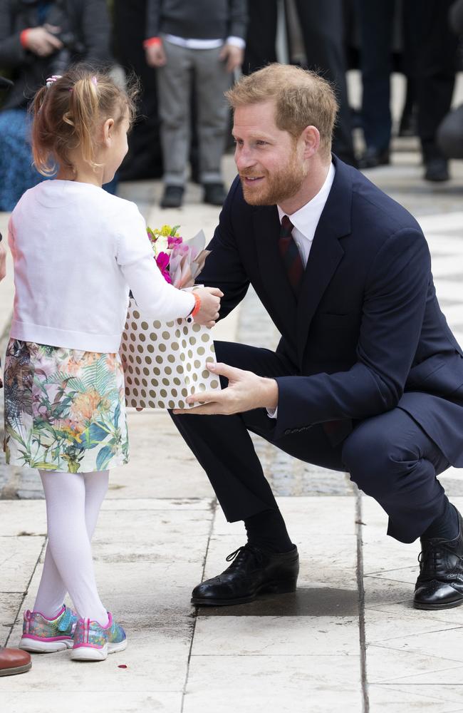 Like his mother, Prince Harry has a warm rapport with children. Here he meets a little girl outside a charity lunch at London’s Guildhall. Picture: Getty Images