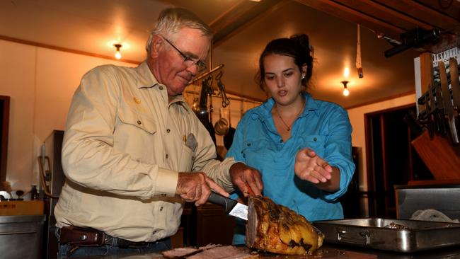 Peter Hughes with cook Makayla Talbot, carving dinner.