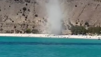 Unsuspecting beachgoers have been caught in a chaotic wind tunnel at a popular summer swim spot. Nine News.